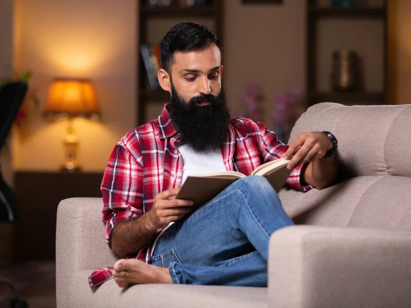 Man reading a book at a table