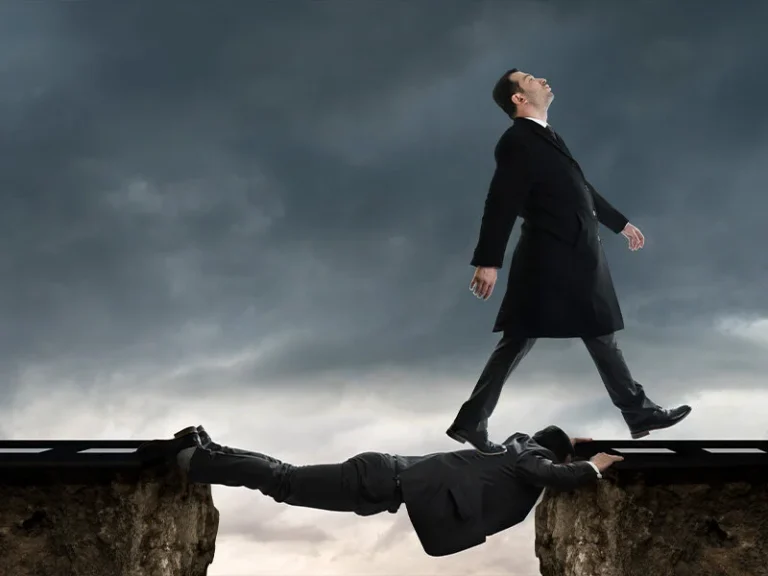 Businessman walking toward the edge of a cliff