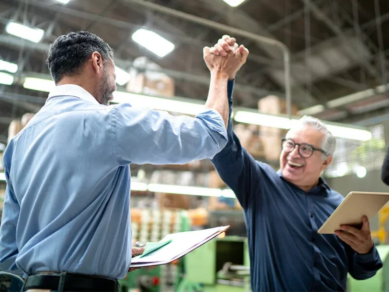 Two colleagues celebrating success with a high five