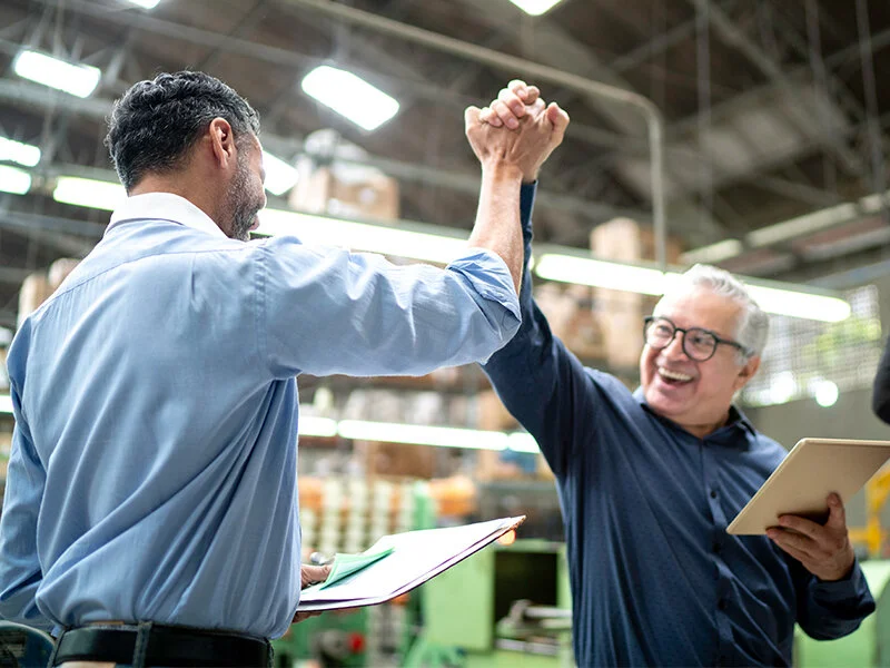 Two colleagues celebrating success with a high five