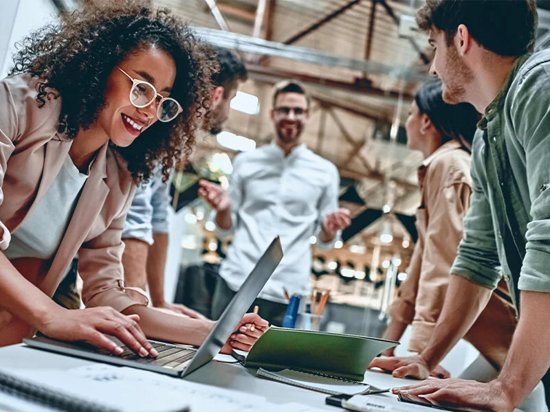 Colleagues collaborating around a table in a workplace