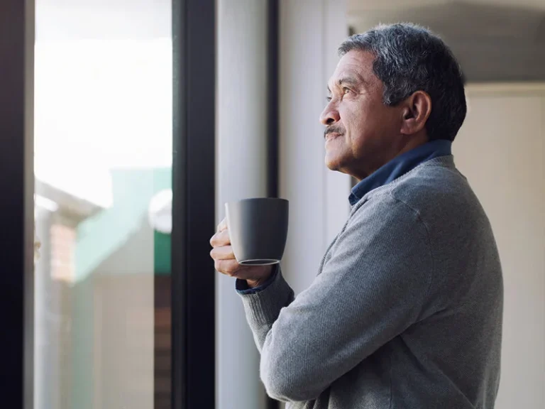 Businessman looking thoughtfully out of a window